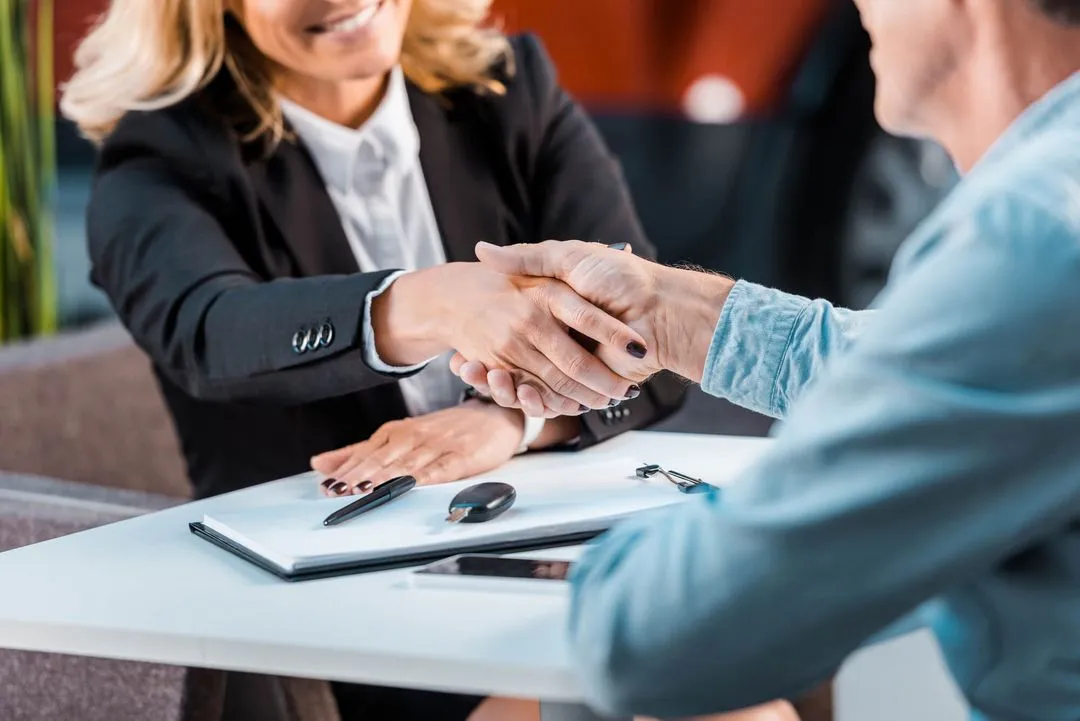 Business woman shaking hands with a client